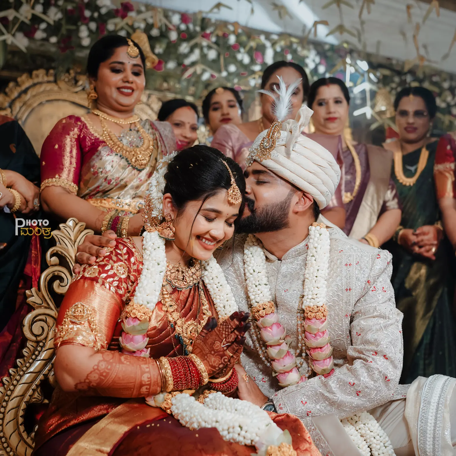 Symmetrical drone shot of a traditional floral mandap at a beachside wedding in Kundapura, showcasing intricate decor and ocean views.